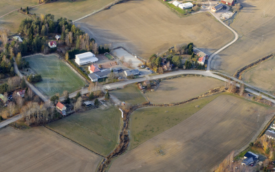 Ilmakuva Lokalahdelta, kuvassa peltoja, joista kaksi lohkoa ovat vuokrattavissa ilmoituksen mukaan.