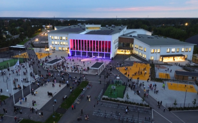 Ilmakuva Wintterin edestä, runsaasti ihmisiä pihalla ihailemassa seinään heijastettua valotaideteosta.